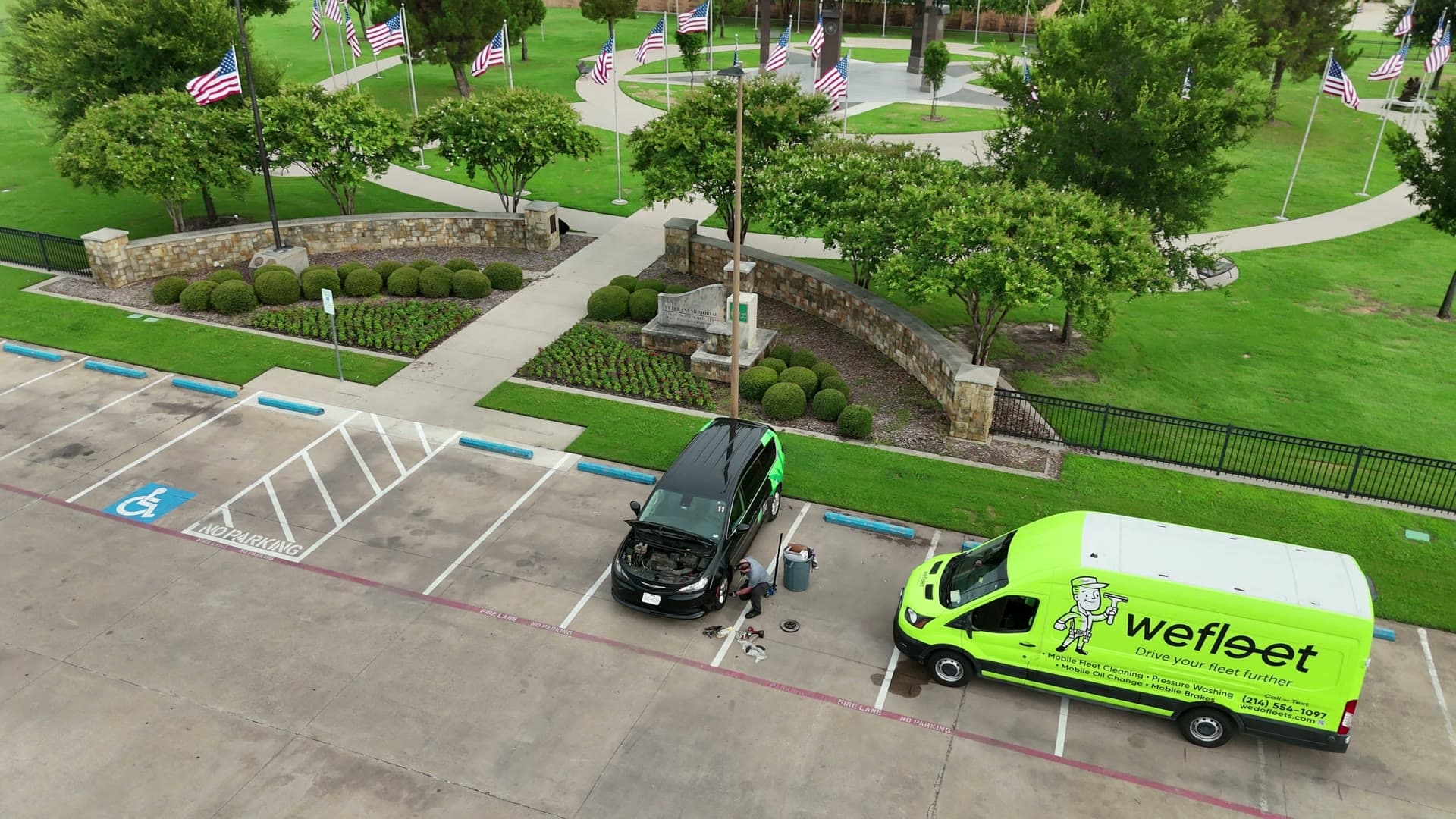 Aerial view of WeFleet’s lime-green mobile workshop at a Dallas fleet lot
