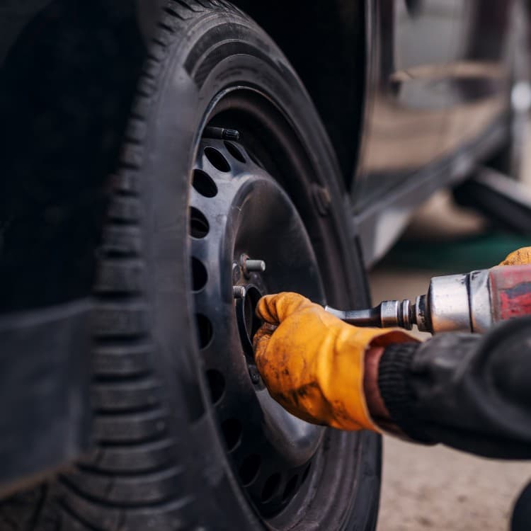 Impact wrench loosening a wheel's lug nuts