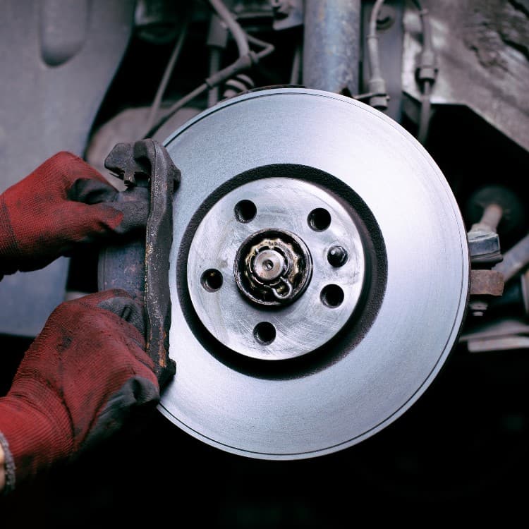 Technician mounting a new brake rotor on the hub