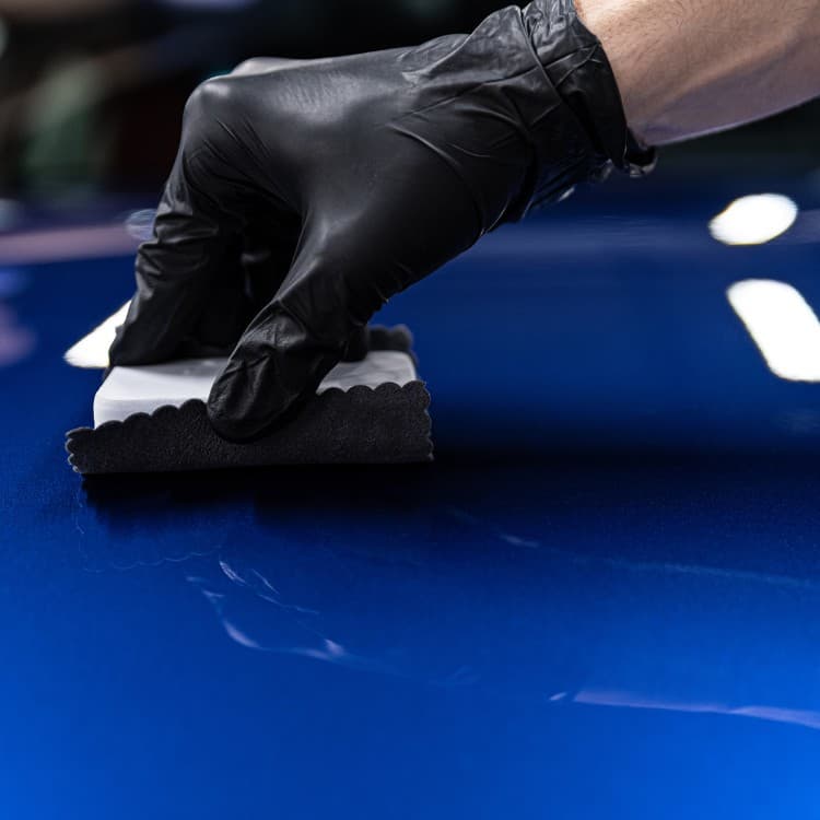 Protective coating applied by hand to blue paint